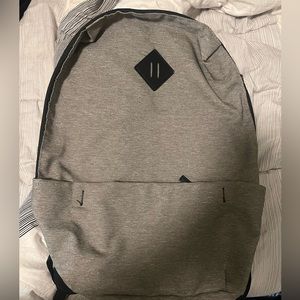Gray Backpack. With front pocket and laptop holder in backpack. Brand new!